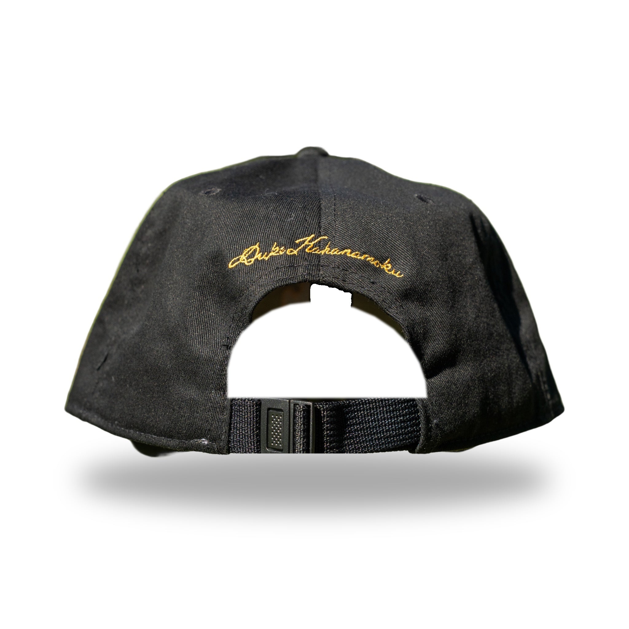 Back of black cap with gold Duke Kahanamoku signature embroidery above adjustable strap