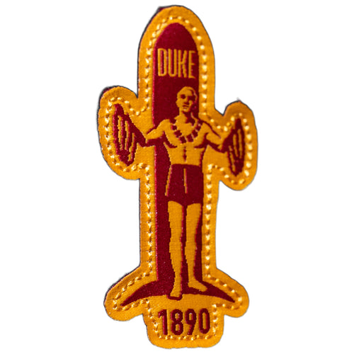 Close-up of red and gold DUKE 1890 surfboard felt patch