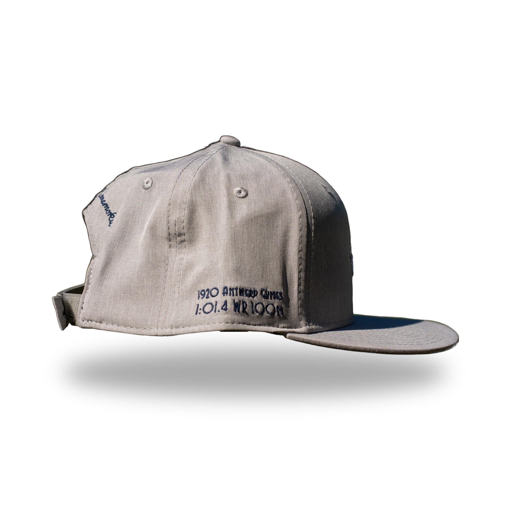 Side of heather gray DUKE cap showing 1920 Antwerp Games 1:01.4 WR 100M embroidery