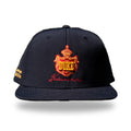 Navy snapback cap with red and gold embroidered Hawaiian royal crest reading DUKE and Kahanamoku script