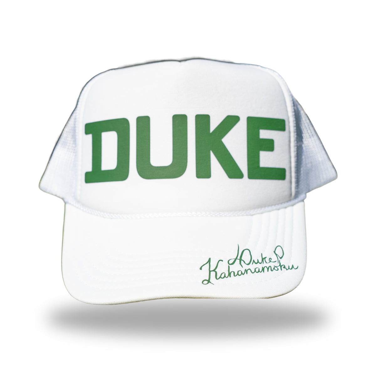 White foam trucker hat with green DUKE lettering and Duke Kahanamoku signature on the brim, front view