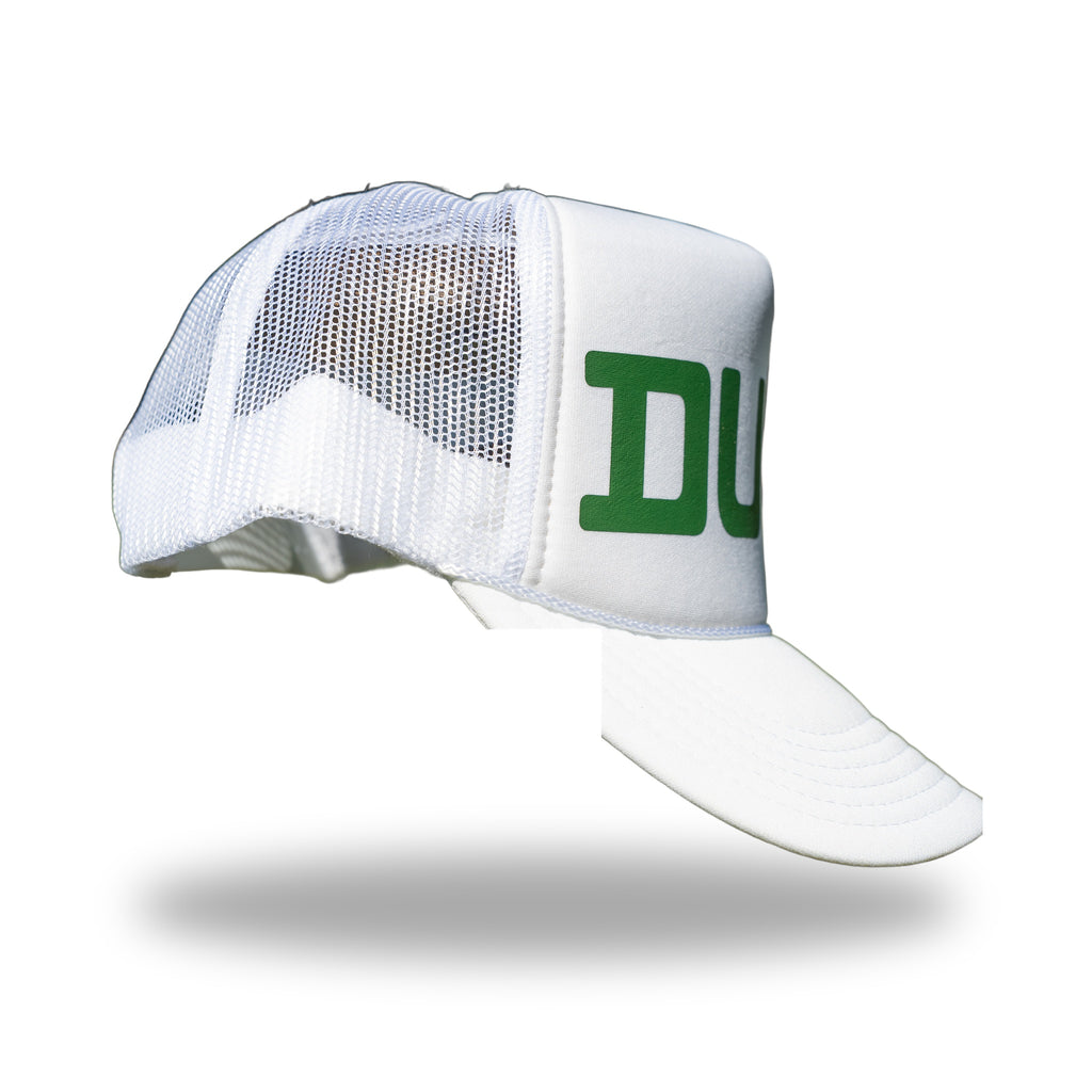 Side profile of white DUKE trucker hat showing breathable white mesh back panels