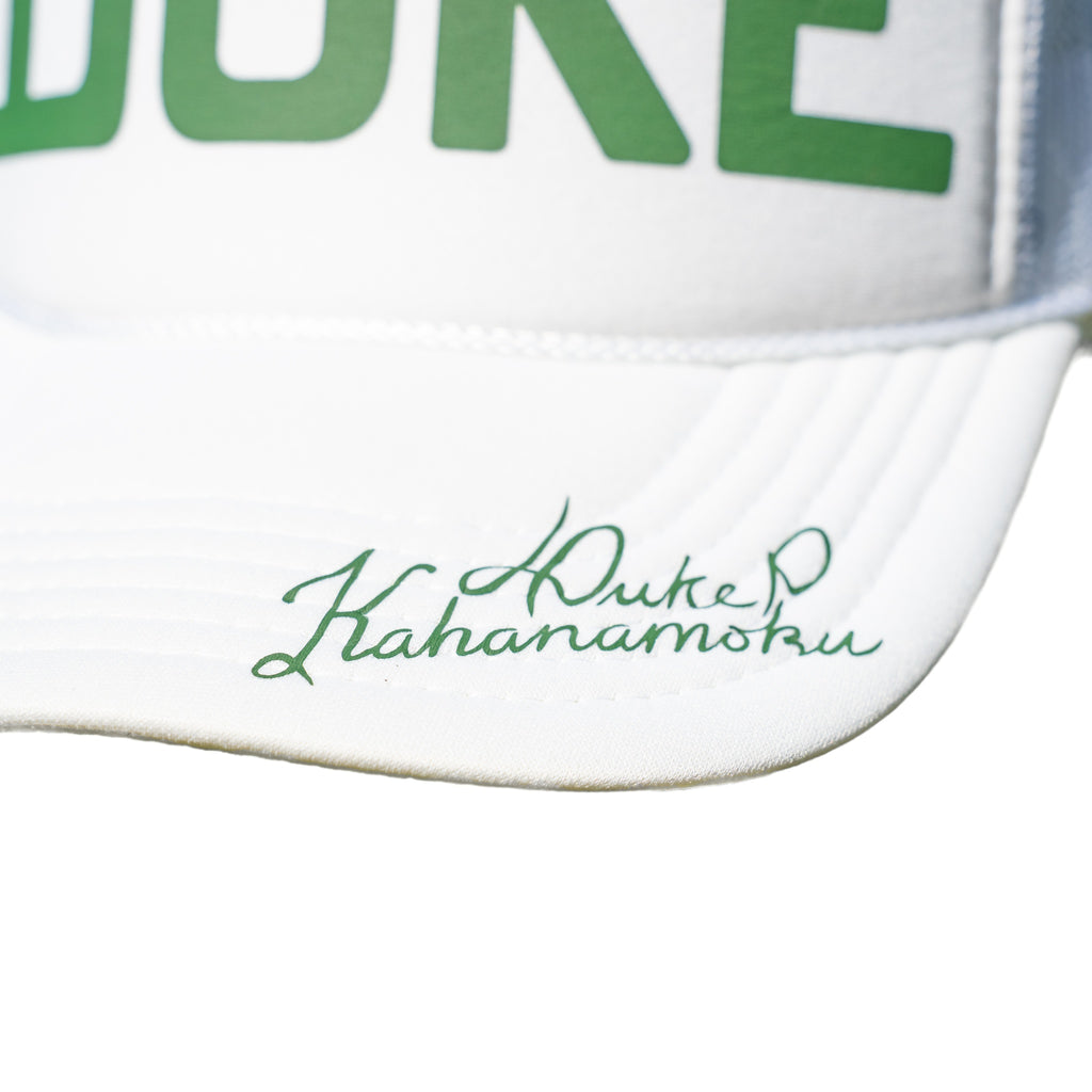 Close-up of the authentic green Duke Kahanamoku script signature printed on the white brim